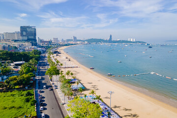 Wall Mural - Pattaya Thailand, a view of the beach road with hotels palm trees and skyscrapers buildings alongside the renovated new beach road on a sunny day