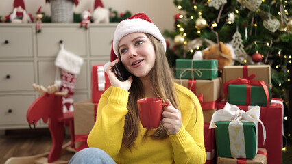 Sticker - Young blonde woman drinking coffee talking on smartphone by christmas treeop09 nm12op0' at home