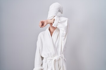 Canvas Print - Blonde caucasian woman wearing bathrobe covering eyes with arm, looking serious and sad. sightless, hiding and rejection concept