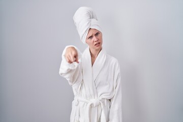 Canvas Print - Blonde caucasian woman wearing bathrobe pointing displeased and frustrated to the camera, angry and furious with you