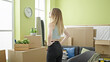 © Krakenimages.com - Young blonde woman standing backwards at new home