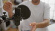 © Krakenimages.com - Man's hands at work, reporter speaking passionately on air at informative radio studio amidst casual indoor lifestyle