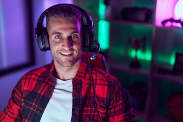 Poster - Young caucasian man streamer playing video game using computer at gaming room