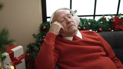 Canvas Print - senior sleeping on sofa listening to music at home