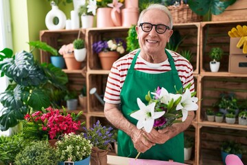 Poster - Middle age grey-haired man florist holding bouquet of flowers at flower shop