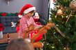 © Krakenimages.com - Brother and sister decorating christmas tree at home