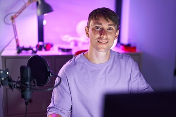 Sticker - Young caucasian man streamer smiling confident sitting on table at gaming room