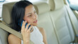© Krakenimages.com - Young beautiful hispanic woman passenger talking on smartphone sitting on car at street