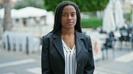 Sticker - African american woman business worker standing with relaxed expression at coffee shop terrace