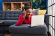 © Krakenimages.com - Young african american with braids working using computer laptop celebrating victory with happy smile and winner expression with raised hands
