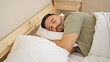 © Krakenimages.com - Young hispanic man lying on bed sleeping at bedroom