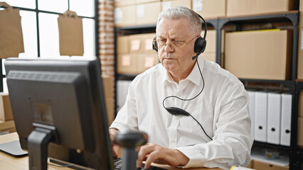 Sticker - Middle age grey-haired man ecommerce business worker using computer and headphones at office