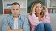 © Krakenimages.com - Man and woman angry couple sitting on sofa together at home