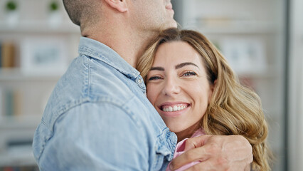 Poster - Man and woman couple hugging each other smiling at home