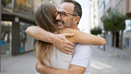 Sticker - Confident father hugging his smiling daughter on a sunny street, sharing joy and happiness together