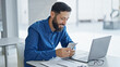 © Krakenimages.com - Young hispanic man business worker using laptop counting dollars at the office