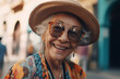 © MaxSafaniuk - Elderly woman with cheerful smile. Grandmother in glasses. Grandma in fashionable clothes on vacation. Cheerful retired Grandmother in bright clothes. Old woman with face smile. Happy pensioner famale
