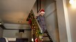 © Kyrylo Ryzhov - Cheerful excited boy in pajamas running down the stairs to open gifts and presents from Santa on Christmas morning. Family celebrations on winter holidays.