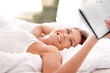 © Mark Freebs/peopleimages.com - Bed, notebook and relax happy woman reading, smile and review agenda schedule, calendar or notes paper. Journal planner, home and morning person check info reminder, checklist and lying on bedroom