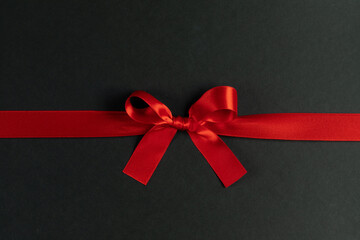 Wall Mural - Red gift bow on black