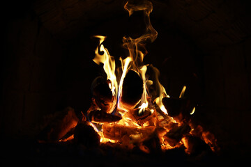 Wall Mural - Background of the flame in the oven. Tongues of fire in a brick fireplace. Fire texture.