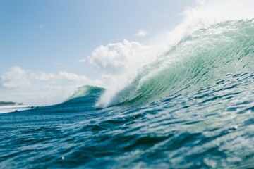 Wall Mural - Beautiful shot of wave breaking in Carcavelos on a sunny day in Portugal