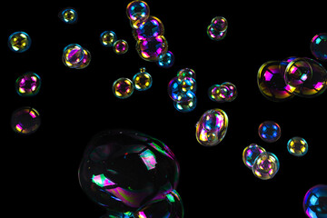 Wall Mural - Soap bubbles isolated on a black background.