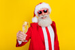 Portrait of positive aged man arm hold champagne glass say toast newyear occasion isolated on yellow color background