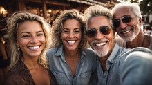 Happy Group Of Smiling Middle Aged Friends Taking A Selfie With Smart Mobile Phone In Front Of Camera Outdoors, Couples Of Senior Friends. Lifestyle Concept With Pensioners Having Fun Together 