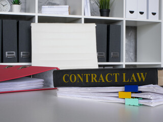 Wall Mural - Contract law book on a stack of papers.