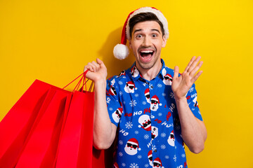 Canvas Print - Photo of young xmas man open mouth screaming new year atmosphere bring red packages discounts promo isolated on yellow color background