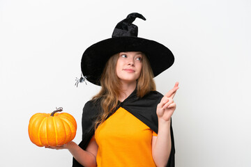 Canvas Print - Young pretty woman costume as witch holding a pumpkin isolated on white background with fingers crossing and wishing the best