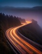 © NickArt - Night mountain road with slow shutter speed on a misty evening of winter coming for low speef safe driving and travelling by car by winter mountain motorway or highway