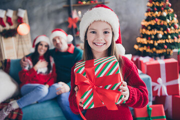 Sticker - Photo of adorable sweet girl hold christmastime giftbox peaceful parents sit sofa enjoy magic time flat indoors