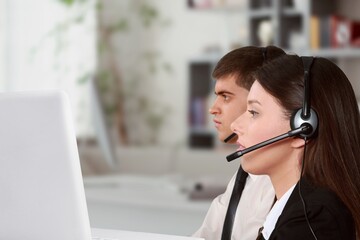 Poster - Technical support worker with a headset in modern office.