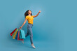 © Prostock-studio - Excited young indian woman shopaholic walking with purchases