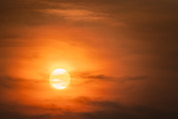 Wall Mural - Scenic golden red sunset, Sun partly behind clouds, tropical sky, close up photo