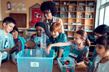 Children Learning How To Recycle Plastic In Elementary Classroom