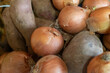 Closeup shot of unpeeled onions and potatoes