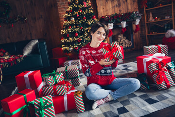 Sticker - Photo of pretty young girl sit floor receive present box wear trendy red sweater festive interior living room presents christmas tree