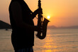 Musician playing saxophone during sunset