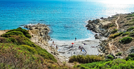 Wall Mural - Secluded small pebble sand beach between rocks on the french mediterranean sea near St. Tropez- l escalet, Ramatuelle, France