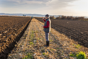 Wall Mural - Farmer with tablet in field in winter time