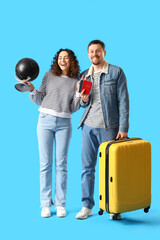 Sticker - Young couple with passports, globe and suitcase on blue background