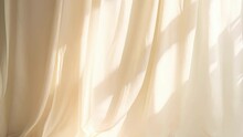 A minimalistic abstract background showcasing a pale yellow light softly pouring through a curtain onto a textured linen fabric. The delicate shadows create a serene