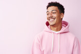 Fototapeta  - The portrait of a cute and handsome male teeager in a pink, blue hoodie standing and looking at the camera, isolated on a pink, blue background. Generative AI.