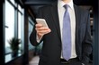 © BillionPhotos.com - Smiling mature businessman posing in office with phone.