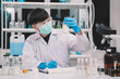 © Atthapon - Nutritionist or scientist is looking a bottle of sample milk. Dairy milk test, research or analysis product