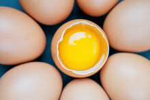 Top View Macro Shot Of Eggs With One Chicken Egg Broken With Yolk