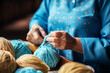 © toonsteb - close up of hands making balls of yarn bokeh style background